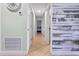 Hallway featuring tile flooring and view into other rooms with neutral wall paint and decorative accent wall at 4026 Seabridge Dr, Orlando, FL 32839