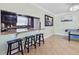 Kitchen and game room featuring a breakfast bar with stools, tile flooring, and stylish decor at 4026 Seabridge Dr, Orlando, FL 32839