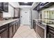 Modern kitchen equipped with stainless steel appliances, granite countertops, and dark wood cabinetry at 4026 Seabridge Dr, Orlando, FL 32839