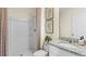 Clean bathroom with a granite countertop vanity, framed art, and a shower behind a decorative curtain at 4094 Giorgio Dr, Winter Haven, FL 33884