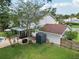 Drone view of the home featuring the back yard, detached garage, and an enclosed lanai at 4536 Misty Morn Cir, Orlando, FL 32812