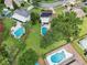 Birds-eye view of a home surrounded by pools and greenery in a suburban neighborhood at 4536 Misty Morn Cir, Orlando, FL 32812
