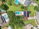 Aerial view of property featuring a pool, solar panels, and well-maintained landscaping at 4536 Misty Morn Cir, Orlando, FL 32812