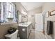 Neutral bathroom with a double vanity, framed mirror, and soft natural light from the window at 4536 Misty Morn Cir, Orlando, FL 32812