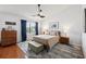 Well-lit bedroom featuring a large window with blue curtains, comfortable bedding, and a unique ceiling fan at 4536 Misty Morn Cir, Orlando, FL 32812