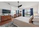 Spacious bedroom with a large window, decorative accents, and a modern ceiling fan at 4536 Misty Morn Cir, Orlando, FL 32812