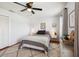 Comfortable bedroom boasts wood floors, white walls, soft rug, ceiling fan and two windows at 4536 Misty Morn Cir, Orlando, FL 32812