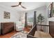 Stylish Bedroom with wood floors, rocking chair, modern crib, and plenty of natural light at 4536 Misty Morn Cir, Orlando, FL 32812