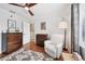 Comfortable Bedroom with wood floors, accent chair, dark wood dresser, and nice decor at 4536 Misty Morn Cir, Orlando, FL 32812