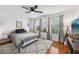 Bright bedroom featuring wood floors, white walls, ceiling fan and two windows with natural light at 4536 Misty Morn Cir, Orlando, FL 32812