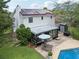 View of a backyard with solar panels, a glass patio, and an outdoor seating area at 4536 Misty Morn Cir, Orlando, FL 32812