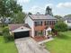 Brick two-story home with solar panels on the roof and a spacious front yard at 4536 Misty Morn Cir, Orlando, FL 32812