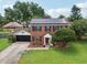 Well-maintained home with a brick facade, solar panels, and a two-car garage at 4536 Misty Morn Cir, Orlando, FL 32812