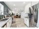 Bright kitchen with stainless steel appliances and view into living area at 4536 Misty Morn Cir, Orlando, FL 32812