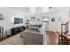 Inviting living room boasts hardwood floors, a stylish gray sectional sofa, and a large TV for entertainment, creating a cozy ambiance at 4536 Misty Morn Cir, Orlando, FL 32812