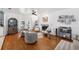 Cozy living room with hardwood floors, comfortable seating, a fireplace, and French doors leading to the outdoors at 4536 Misty Morn Cir, Orlando, FL 32812