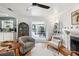 Relaxing living room boasts hardwood floors, comfortable seating, a fireplace, and French doors leading to the outdoor pool area at 4536 Misty Morn Cir, Orlando, FL 32812