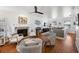 Spacious living room with a fireplace, hardwood floors, comfortable seating and a ceiling fan, creating a cozy and inviting atmosphere at 4536 Misty Morn Cir, Orlando, FL 32812