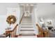 Bright staircase with wood railings leading to the upper level, enhanced by natural light and decorative accents at 4536 Misty Morn Cir, Orlando, FL 32812