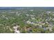 Expansive aerial view showcasing a residential neighborhood with mature trees and lush greenery at 460 Suncrest Ct, Oviedo, FL 32765