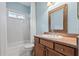 Well-lit bathroom featuring wood cabinets, granite counters and a bathtub at 460 Suncrest Ct, Oviedo, FL 32765