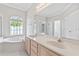 Bright bathroom with double vanity, soaking tub, and a glass enclosed shower at 460 Suncrest Ct, Oviedo, FL 32765