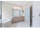 Bright bathroom featuring a double vanity, soaking tub, and a separate doorway at 460 Suncrest Ct, Oviedo, FL 32765