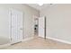 Neutral bedroom with tile flooring and an open doorway to the laundry room at 460 Suncrest Ct, Oviedo, FL 32765