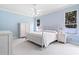 Light blue bedroom featuring white furniture, ceiling fan, and two large windows at 460 Suncrest Ct, Oviedo, FL 32765