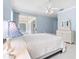 Light blue bedroom featuring a white bed frame, ceiling fan, and sliding glass doors at 460 Suncrest Ct, Oviedo, FL 32765