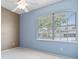 Bright bedroom featuring a ceiling fan and a large window with natural light at 460 Suncrest Ct, Oviedo, FL 32765