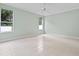 Spacious, light-filled room with tile flooring and large windows overlooking the backyard at 460 Suncrest Ct, Oviedo, FL 32765