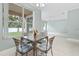 Cozy breakfast nook with backyard views, tile floors, and stylish metal furniture at 460 Suncrest Ct, Oviedo, FL 32765