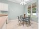 Bright breakfast nook features a modern ceiling fan, tile floors, and a view of the landscaped backyard at 460 Suncrest Ct, Oviedo, FL 32765