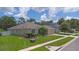Well-maintained single-story home with lush green lawn and colorful landscaping at 460 Suncrest Ct, Oviedo, FL 32765