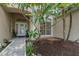 Inviting front entrance with lush greenery and decorative glass doors at 460 Suncrest Ct, Oviedo, FL 32765
