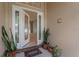 Welcoming front entrance featuring decorative glass doors and potted plants at 460 Suncrest Ct, Oviedo, FL 32765