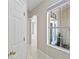 Inviting hallway with tile flooring, arched doorway and a large window at 460 Suncrest Ct, Oviedo, FL 32765