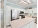 Well-lit kitchen with stainless steel appliances, white cabinetry, and tile flooring at 460 Suncrest Ct, Oviedo, FL 32765