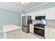 Bright kitchen with stainless steel appliances, white cabinets, and a convenient kitchen island at 460 Suncrest Ct, Oviedo, FL 32765
