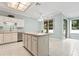 Open concept kitchen features an island, breakfast nook, stainless steel appliances, and tile flooring at 460 Suncrest Ct, Oviedo, FL 32765