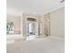 Bright living room boasts neutral walls, plush carpet, and a stylish front door at 460 Suncrest Ct, Oviedo, FL 32765
