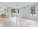 Spacious, tiled living room with a ceiling fan and access to the porch at 460 Suncrest Ct, Oviedo, FL 32765