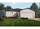 Charming single-Gathering home featuring a two-car garage, neutral paint, landscaped yard, and stone accents at 5001 Kaia Ave, Winter Haven, FL 33884