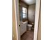 Bathroom with a single sink vanity, mirror, and toilet at 5265 Broken Arrow Dr, Kissimmee, FL 34746