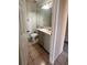 Clean bathroom featuring a vanity with sink, a toilet, a mirror, and a towel bar at 5265 Broken Arrow Dr, Kissimmee, FL 34746