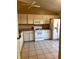 Functional kitchen featuring classic appliances, tile floors, and ample cabinet storage space at 5265 Broken Arrow Dr, Kissimmee, FL 34746