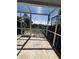 Relaxing screened patio with a tranquil view of the backyard and pond at 5265 Broken Arrow Dr, Kissimmee, FL 34746
