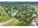 Overhead view of home surrounded by verdant trees within a well-established neighborhood near a green golf course at 5704 Bay Side Dr, Orlando, FL 32819