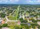Elevated shot showcases house in a leafy community with a golf course and a pond at 5704 Bay Side Dr, Orlando, FL 32819